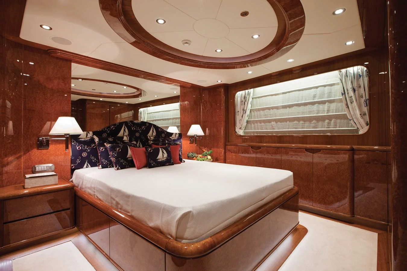 a room with a bed and a mirror aboard BARON TRENCK Yacht for Charter