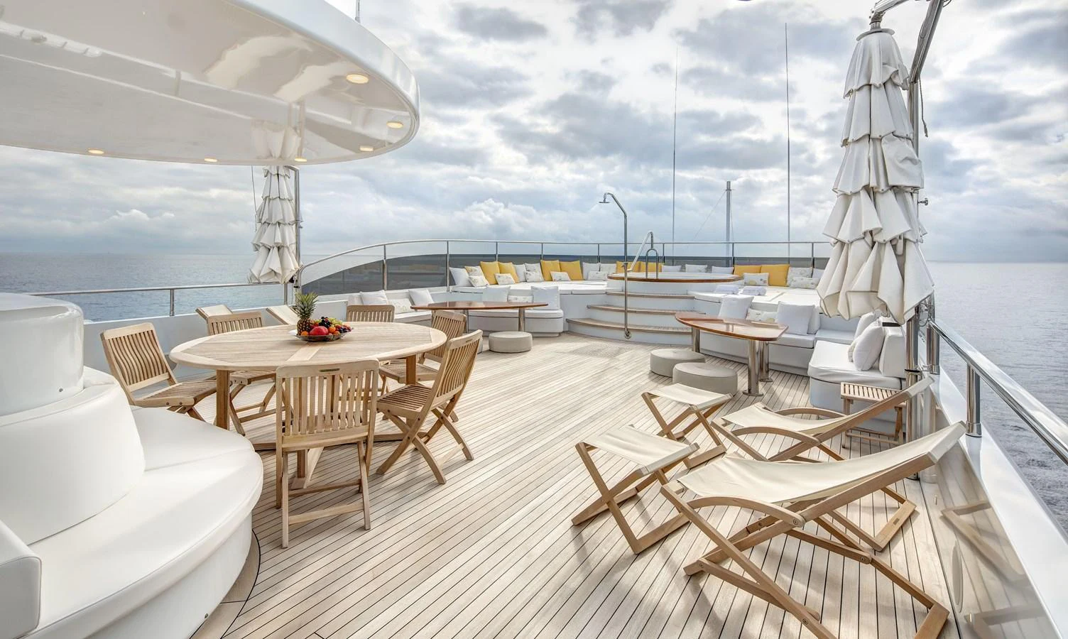 a deck with chairs and tables on it aboard BARON TRENCK Yacht for Charter