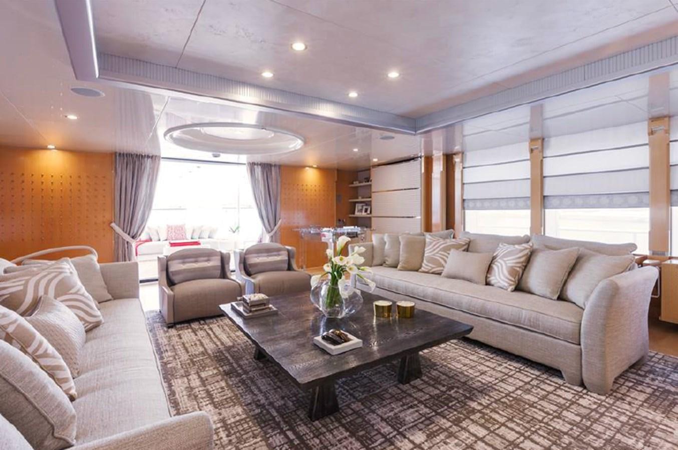a living room with a couch and a coffee table aboard AMORE MIO 2 Yacht for Sale