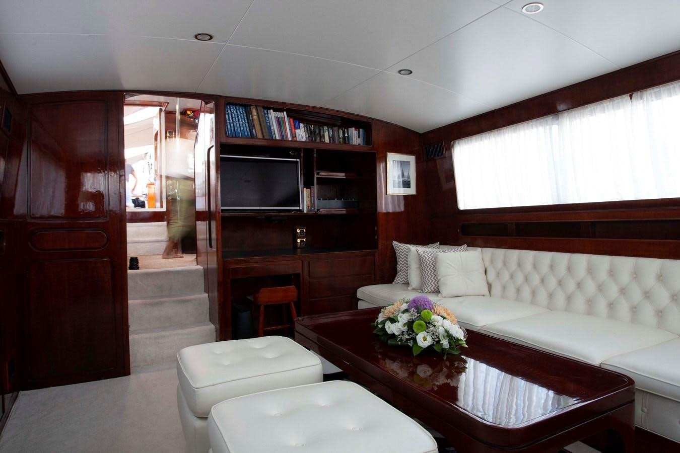a living room with a couch and a television aboard LAMADINE Yacht for Sale