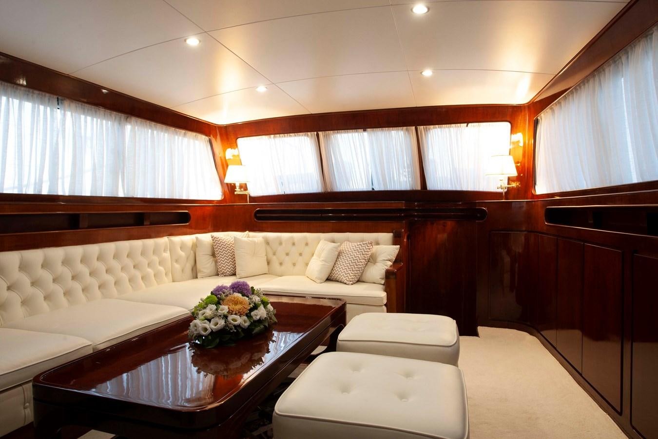 a living room with a large sofa aboard LAMADINE Yacht for Sale