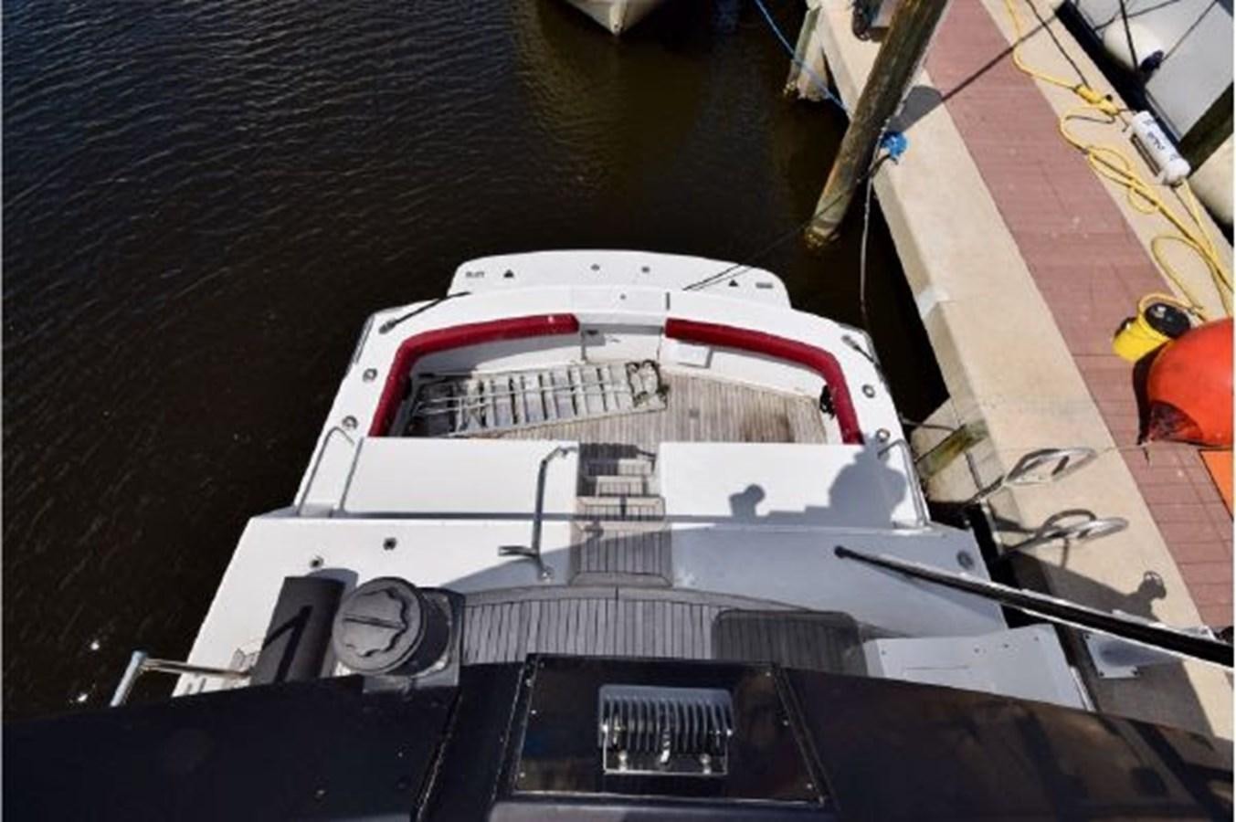 a white and red race car on a track aboard MAC LL Yacht for Sale