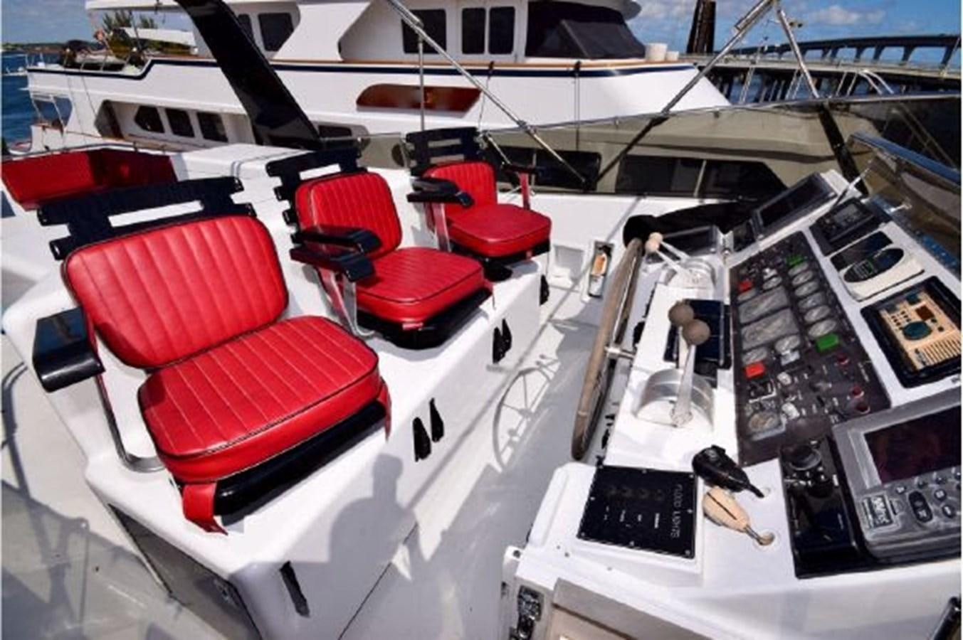 a white table with red chairs and a red table with a white table and red chairs aboard MAC LL Yacht for Sale