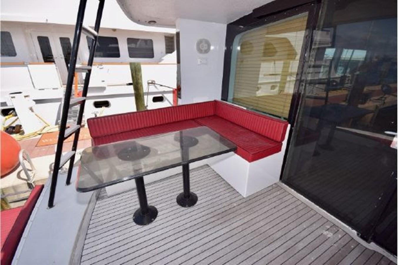 a table with a red cloth on it aboard MAC LL Yacht for Sale