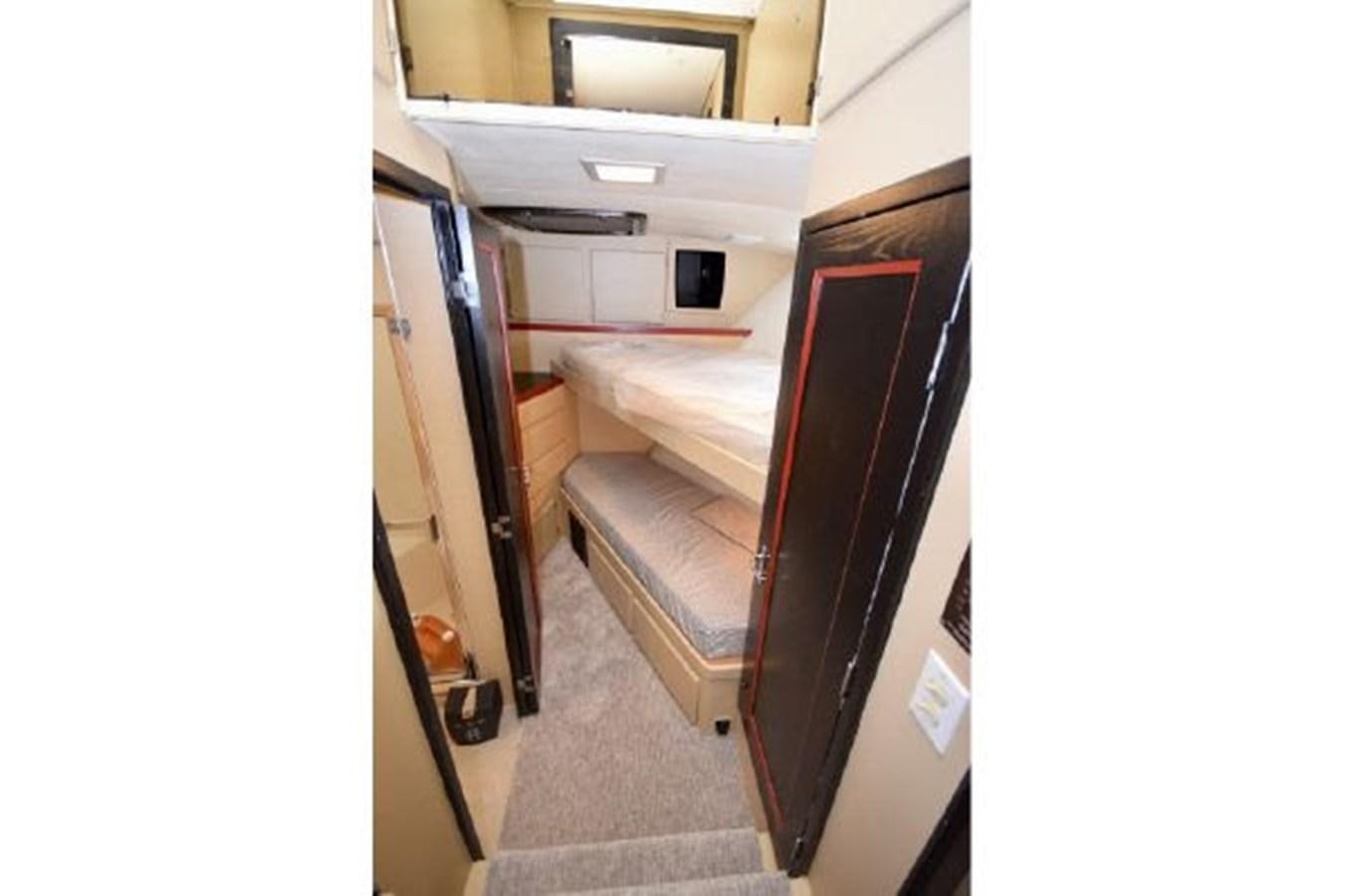 a room with a bed and a closet aboard MAC LL Yacht for Sale