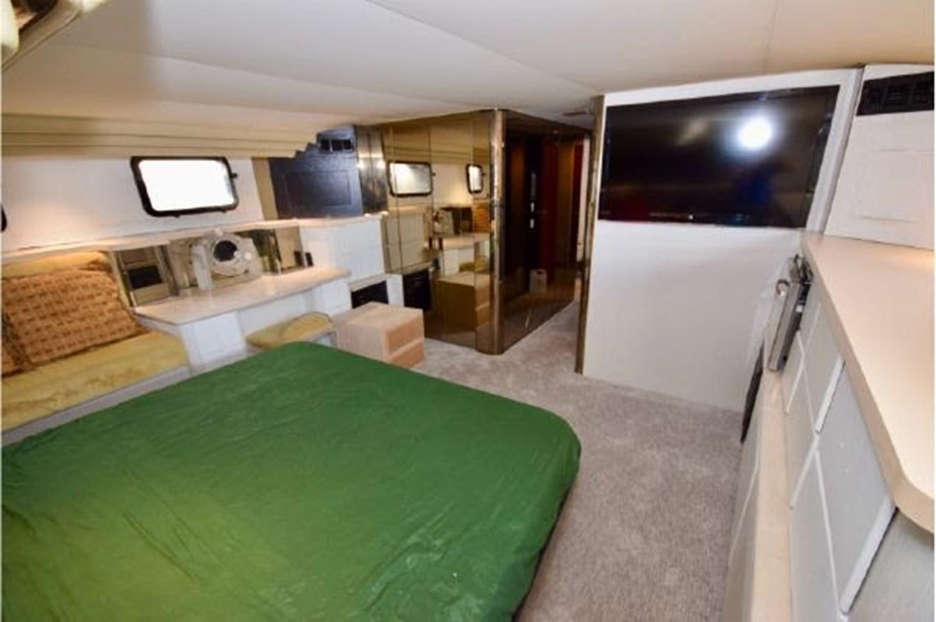a bedroom with a bed and a television aboard MAC LL Yacht for Sale