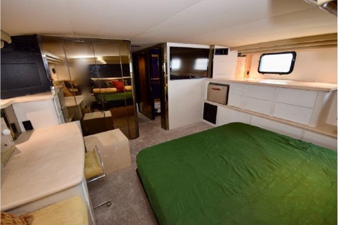 a room with a bed and a television aboard MAC LL Yacht for Sale