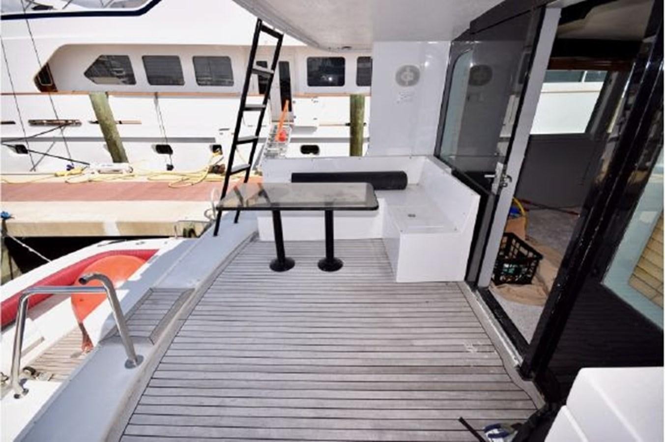 a boat with a desk and a chair on it aboard MAC LL Yacht for Sale
