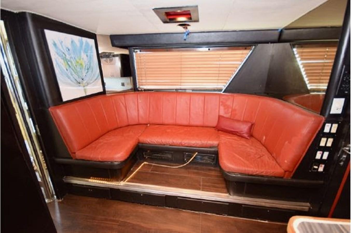 a red couch in a room aboard MAC LL Yacht for Sale