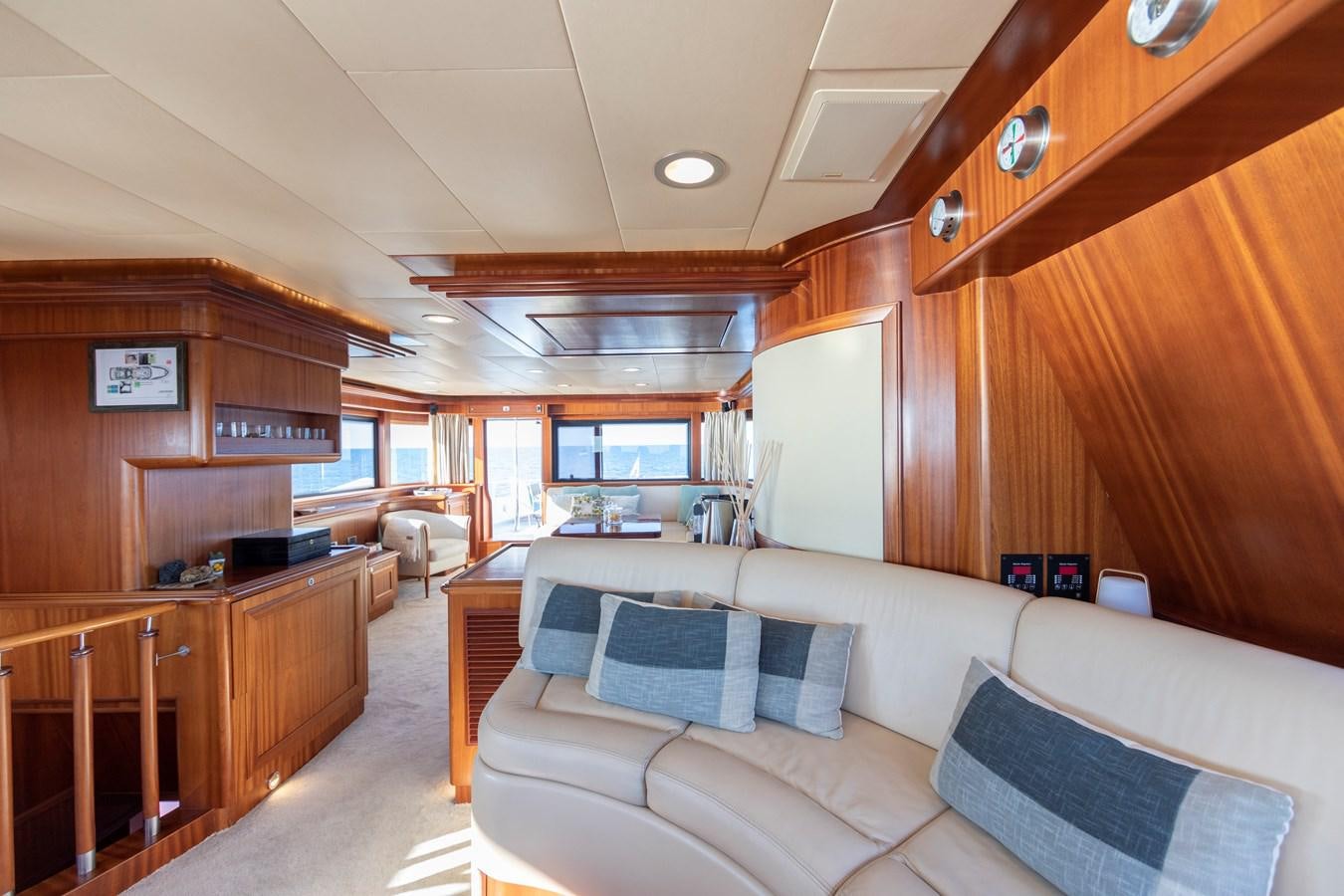 a living room with wood cabinets aboard BIM Yacht for Sale