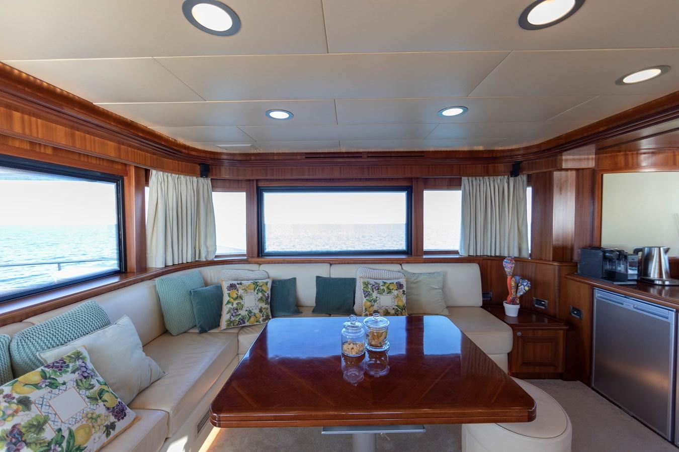 a living room with a table and couches aboard BIM Yacht for Sale