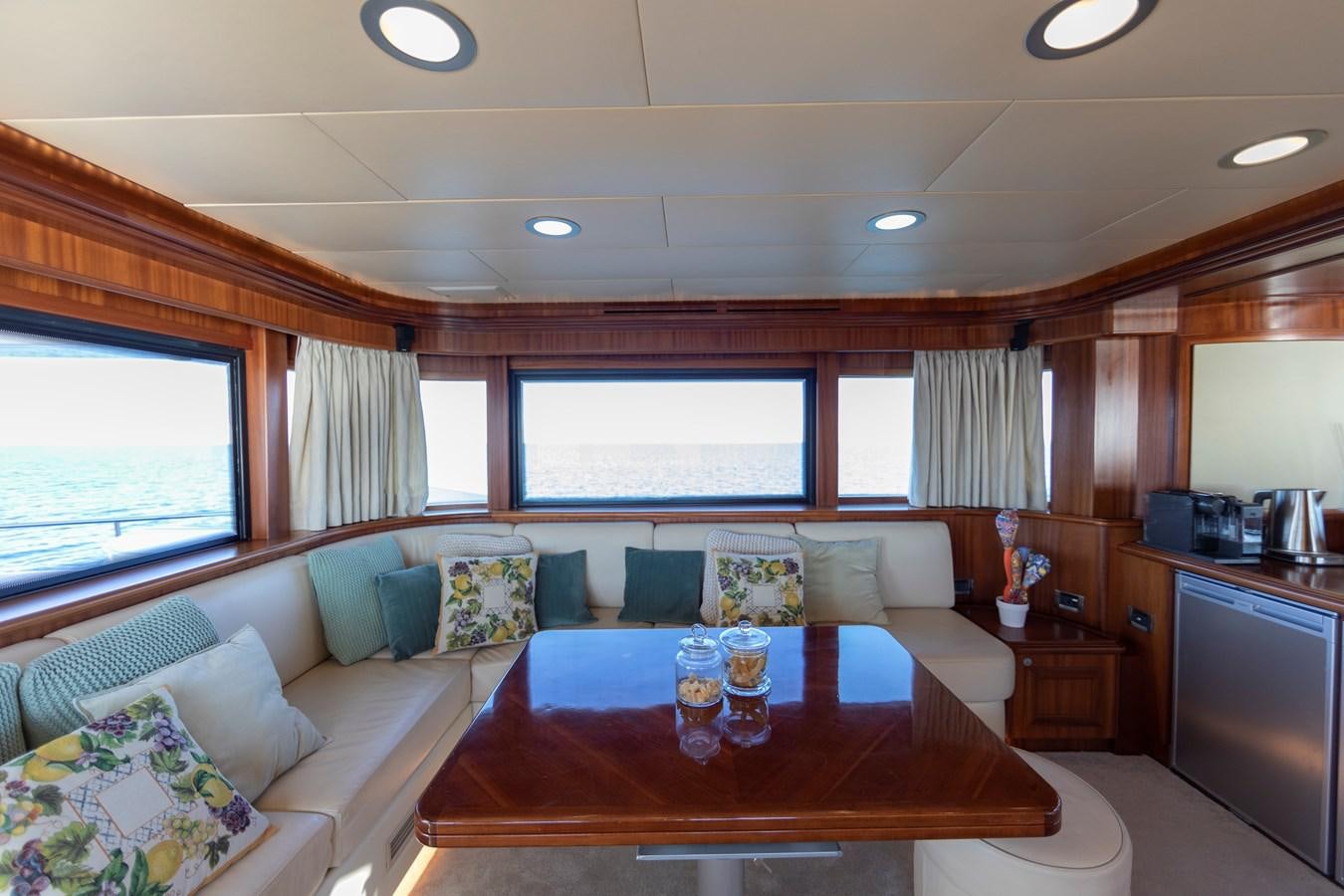 a living room with a table and couches aboard BIM Yacht for Sale