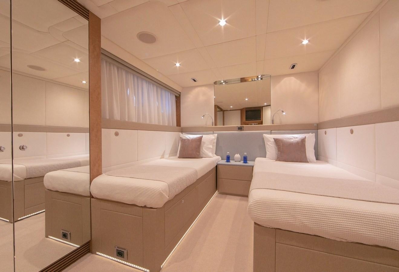a room with a bed and a mirror aboard BENITA BLUE Yacht for Charter