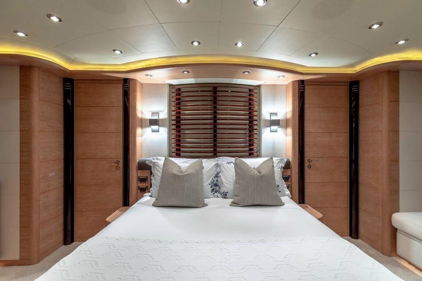 a bed with a white sheet and pillows aboard AERO Yacht for Sale