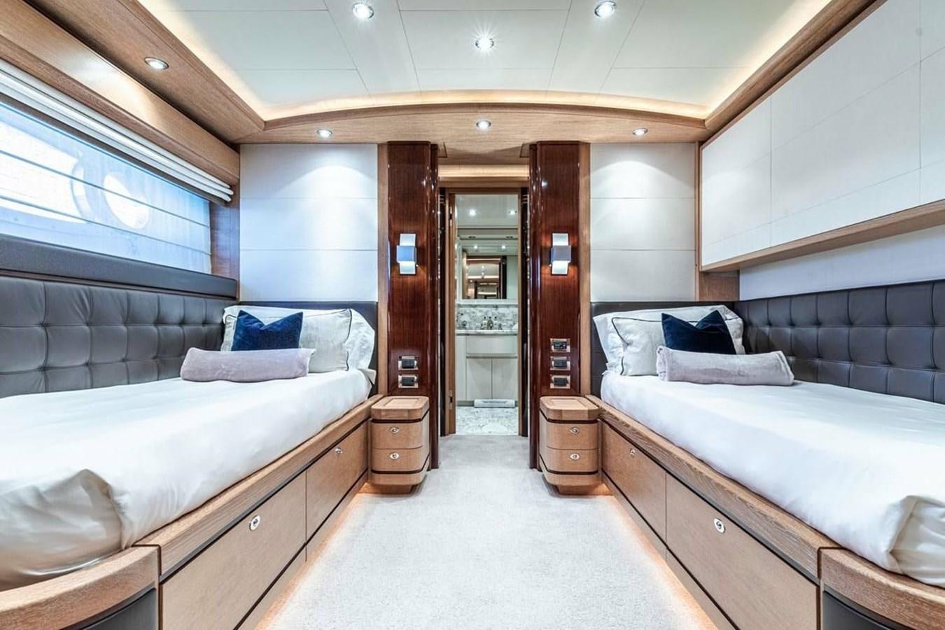 a room with a couple of beds aboard AERO Yacht for Sale