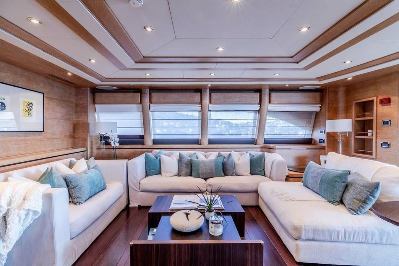 a living room with a couch and a table aboard AERO Yacht for Sale