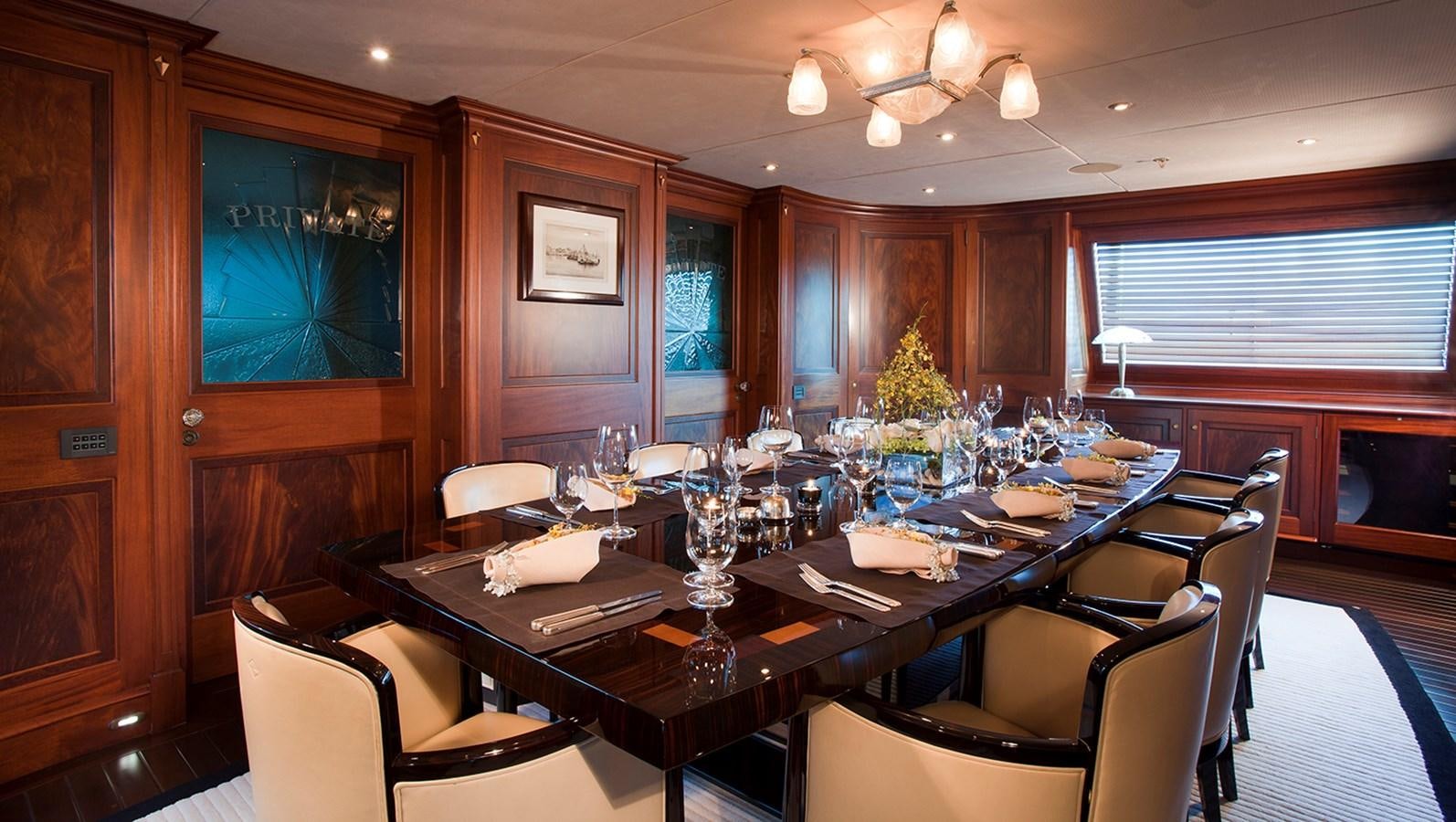 a dining table in a restaurant aboard TIARA II Yacht for Sale