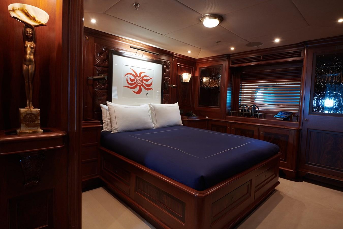 a bedroom with a bed and a desk aboard TIARA II Yacht for Sale