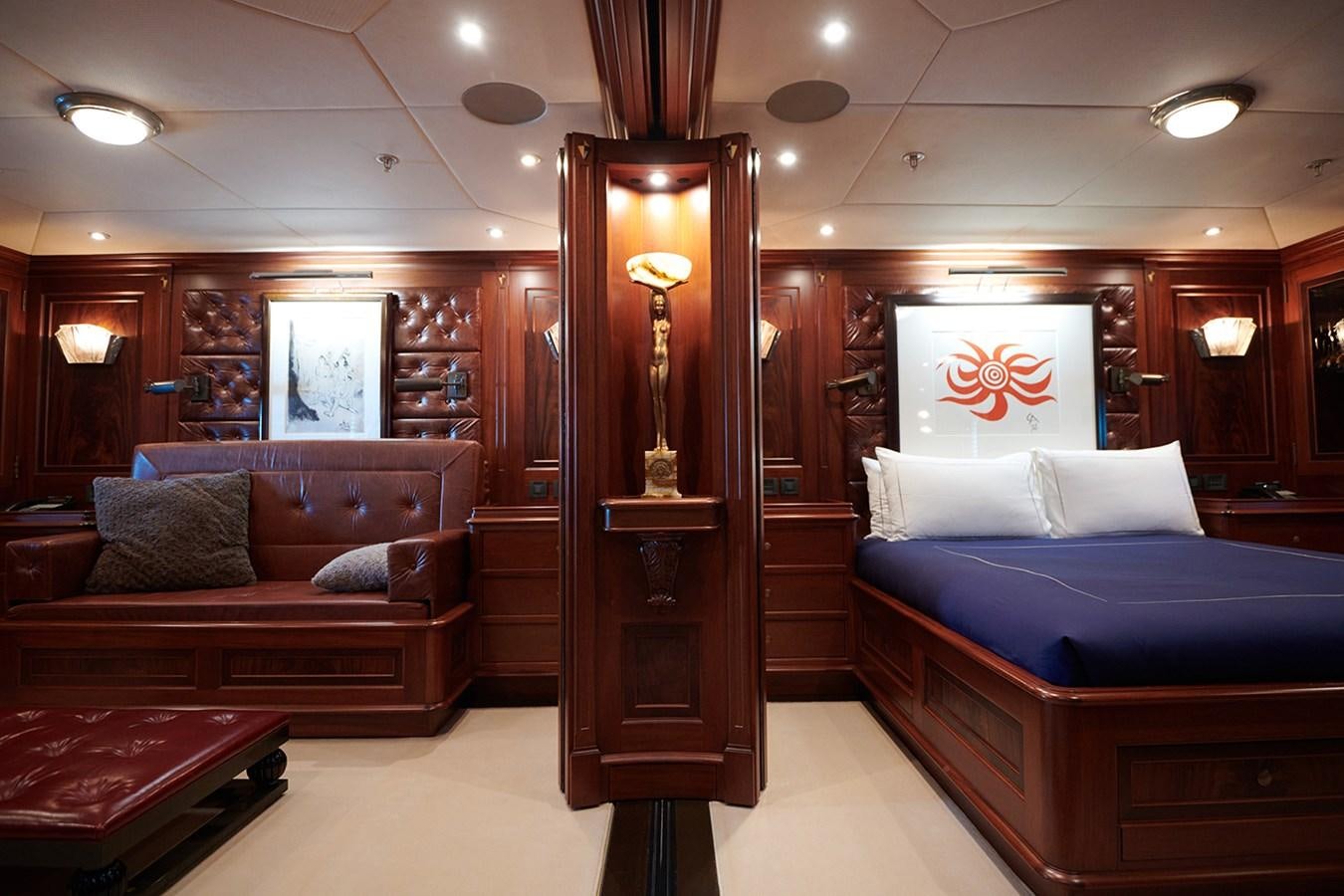 a room with a bed and a lamp aboard TIARA II Yacht for Sale