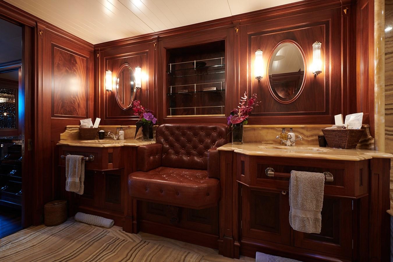 a bathroom with a mirror and a couch aboard TIARA II Yacht for Sale