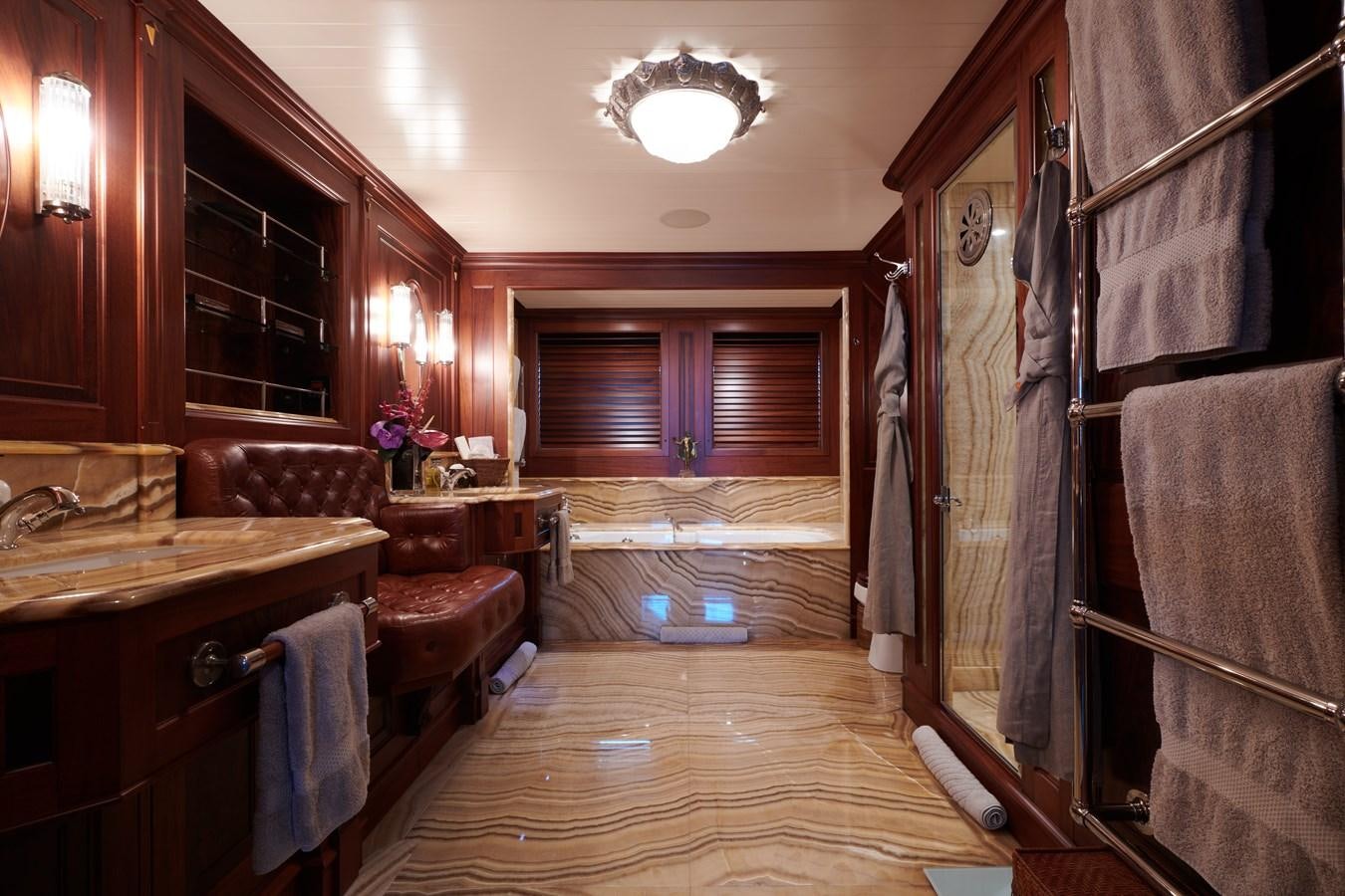 a large bathroom with a wood floor aboard TIARA II Yacht for Sale
