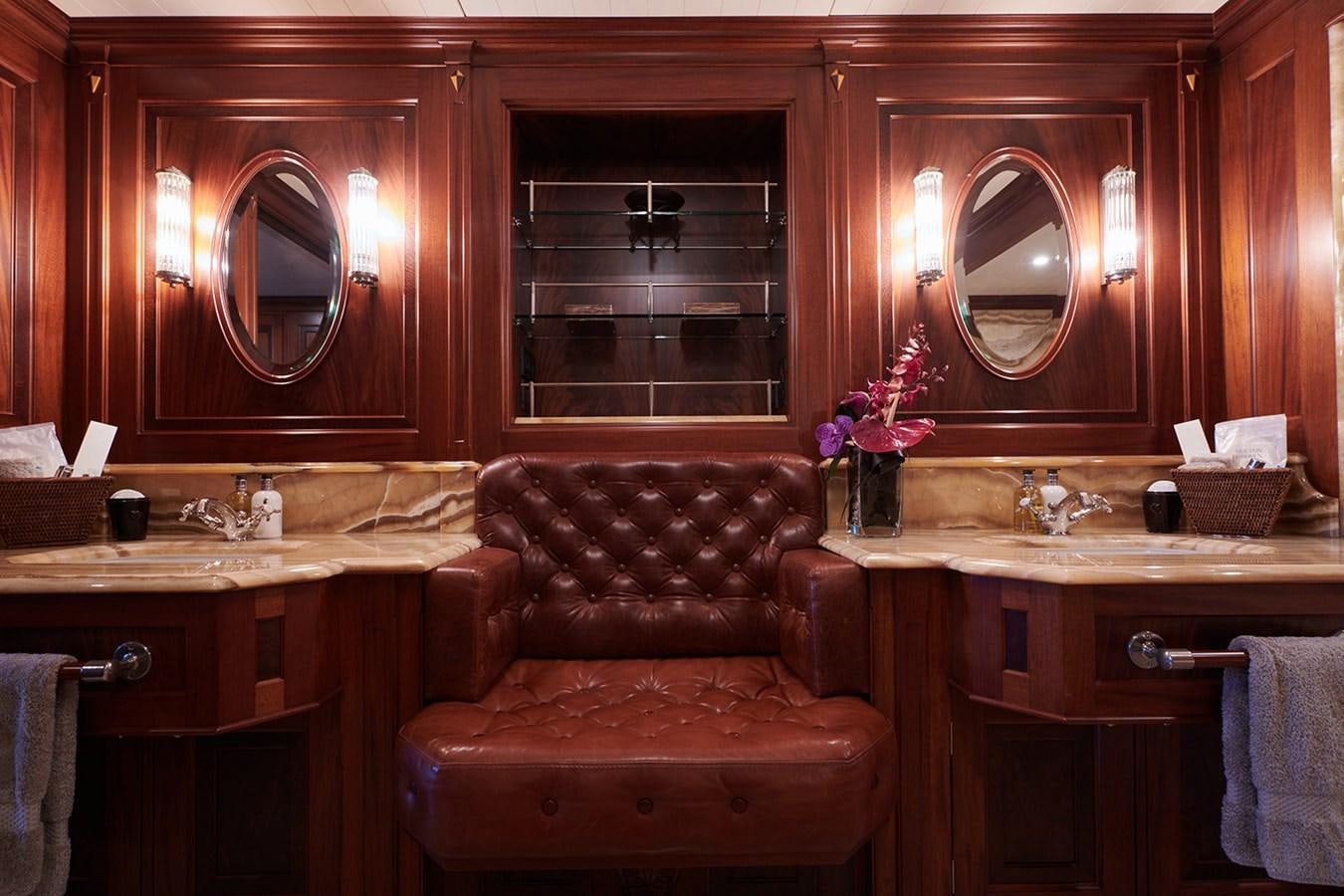a room with a leather chair and a mirror aboard TIARA II Yacht for Sale