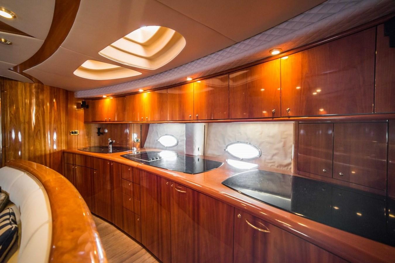 a kitchen with wooden cabinets aboard LE CHIFFRE Yacht for Sale