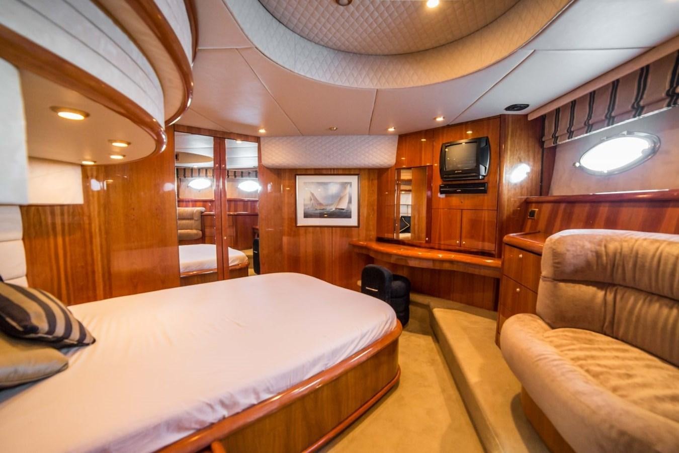 a room with a bed and a couch aboard LE CHIFFRE Yacht for Sale