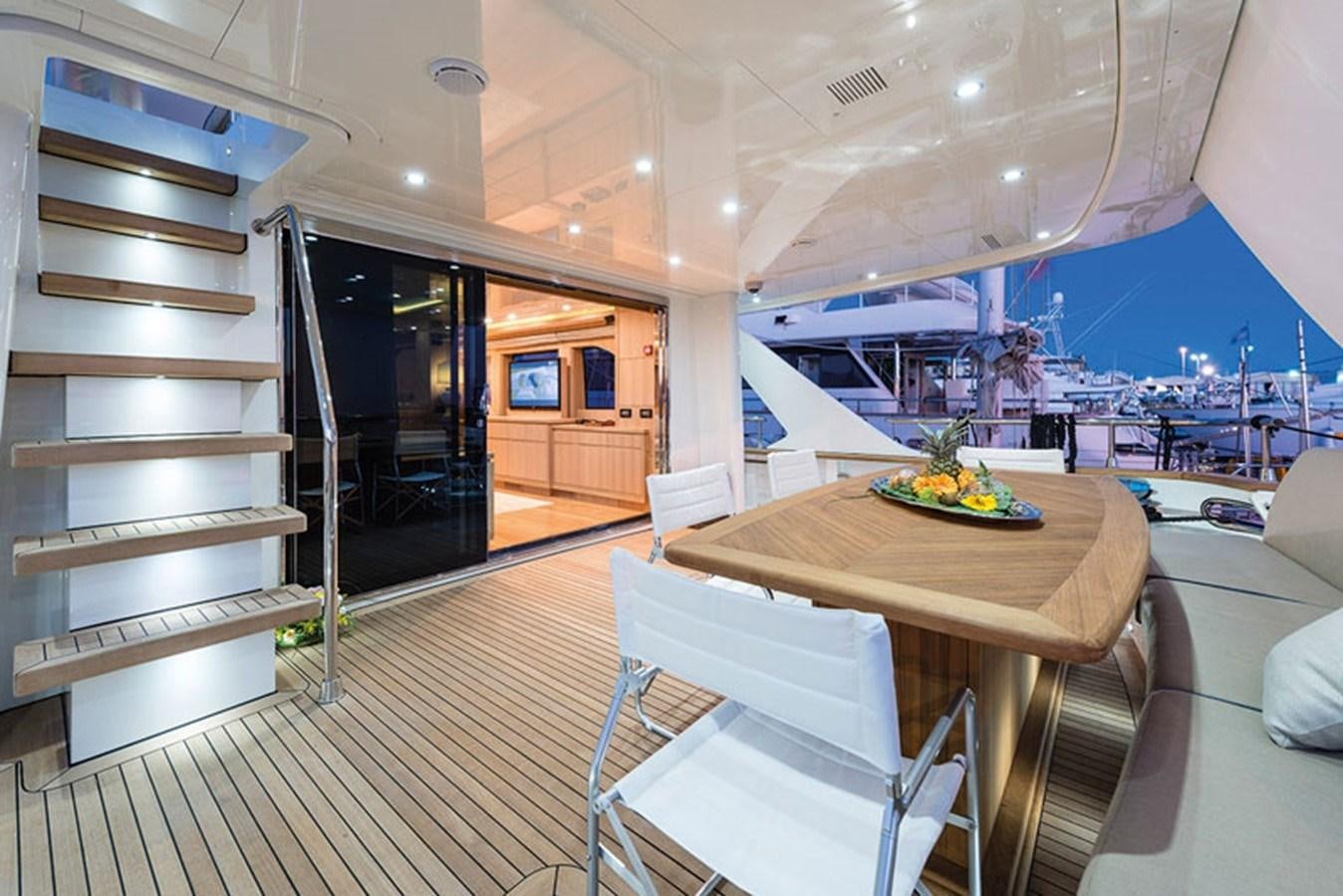 a room with a table and chairs aboard UNICA Yacht for Sale