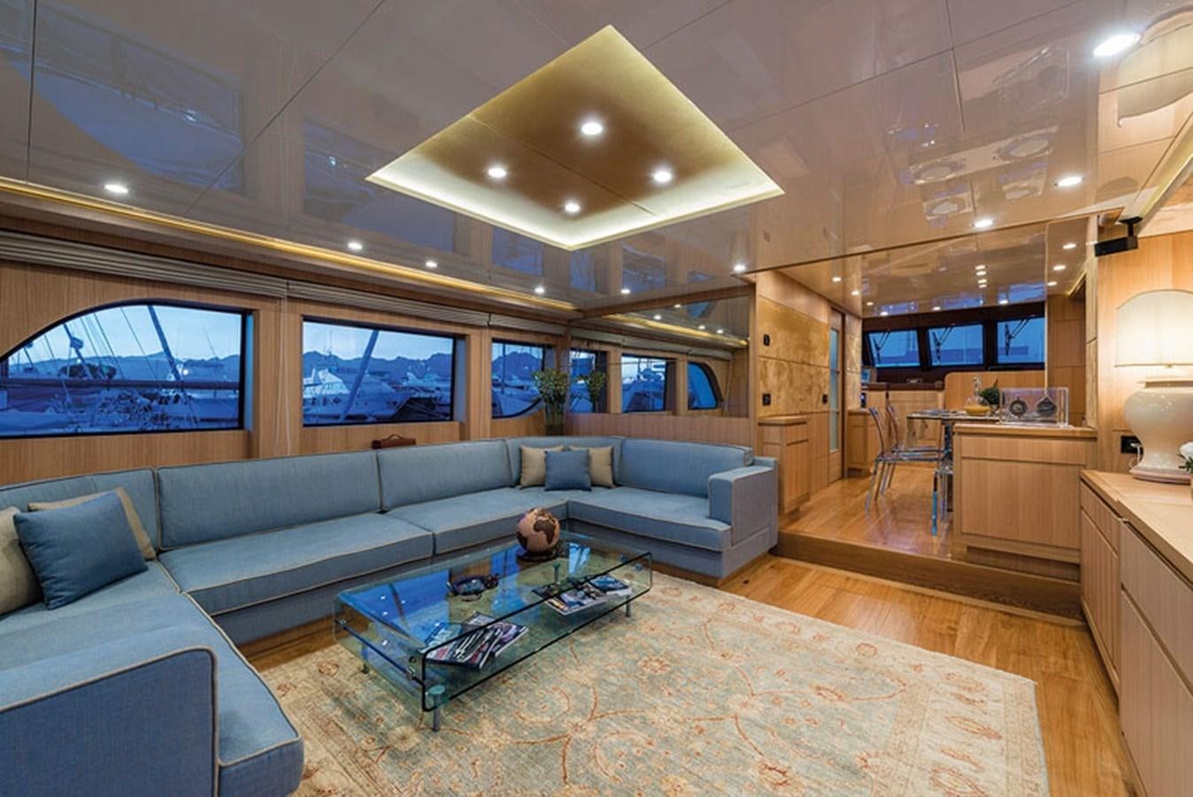 a living room with a large sofa aboard UNICA Yacht for Sale