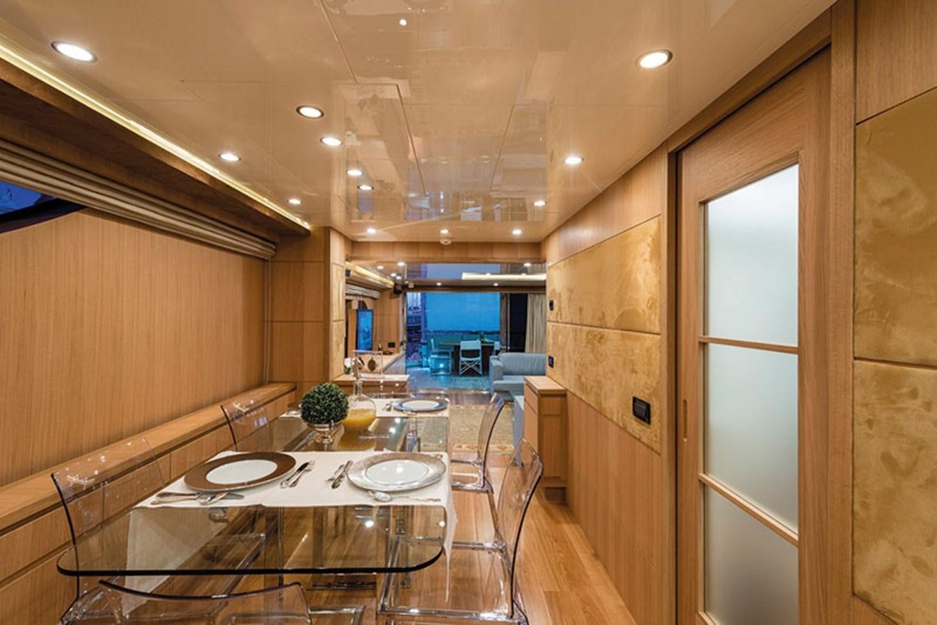 a large kitchen with a dining table aboard UNICA Yacht for Sale