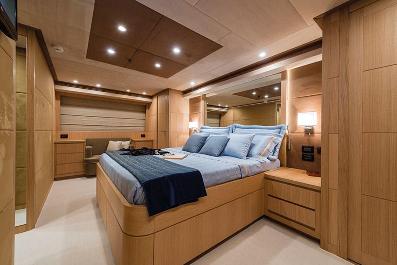 a room with a bed and a desk aboard UNICA Yacht for Sale