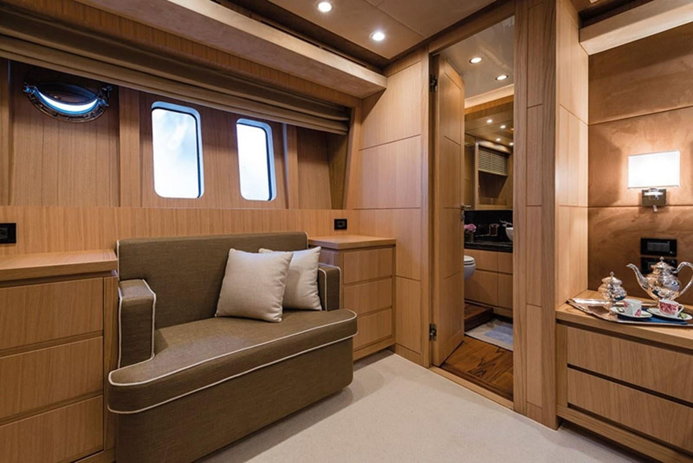 a room with a couch and a mirror aboard UNICA Yacht for Sale