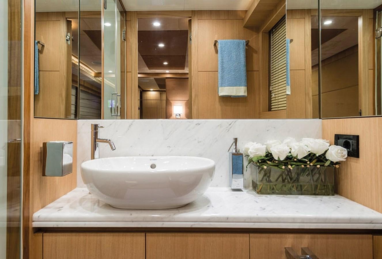 a bathroom with a sink and mirror aboard UNICA Yacht for Sale