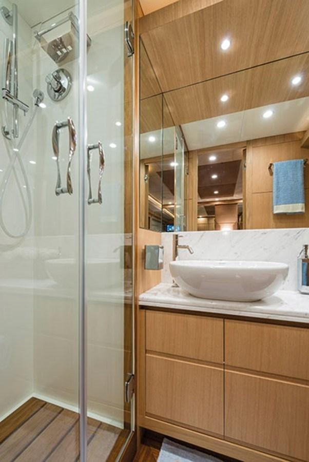 a bathroom with a glass shower door aboard UNICA Yacht for Sale
