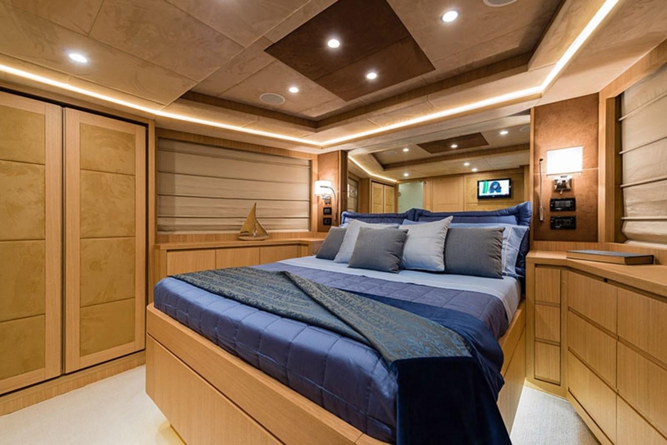 a bedroom with a bed and a desk aboard UNICA Yacht for Sale
