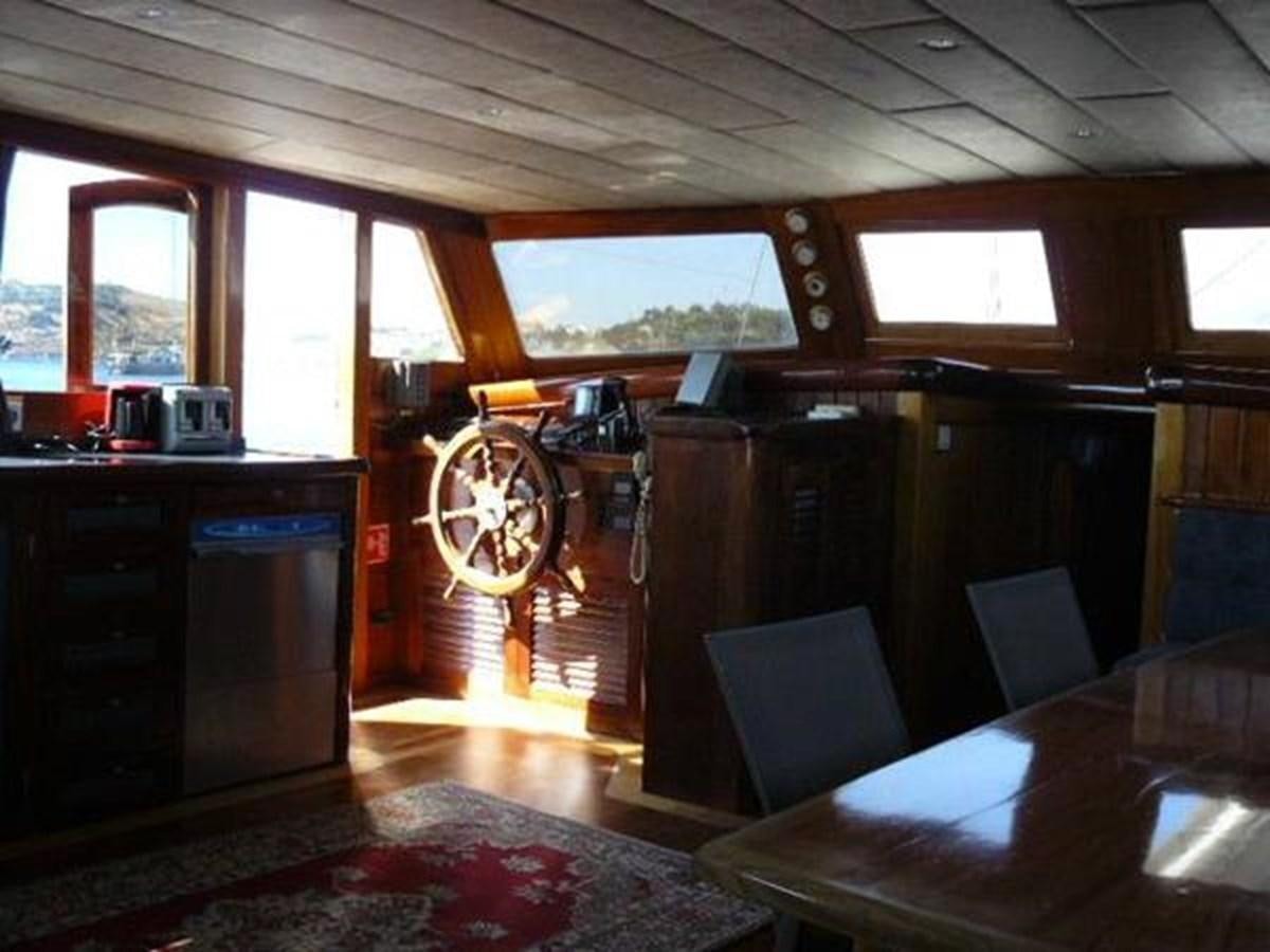 a room with a table and chairs aboard 1998 CUSTOM SAILING YACHT Yacht for Sale