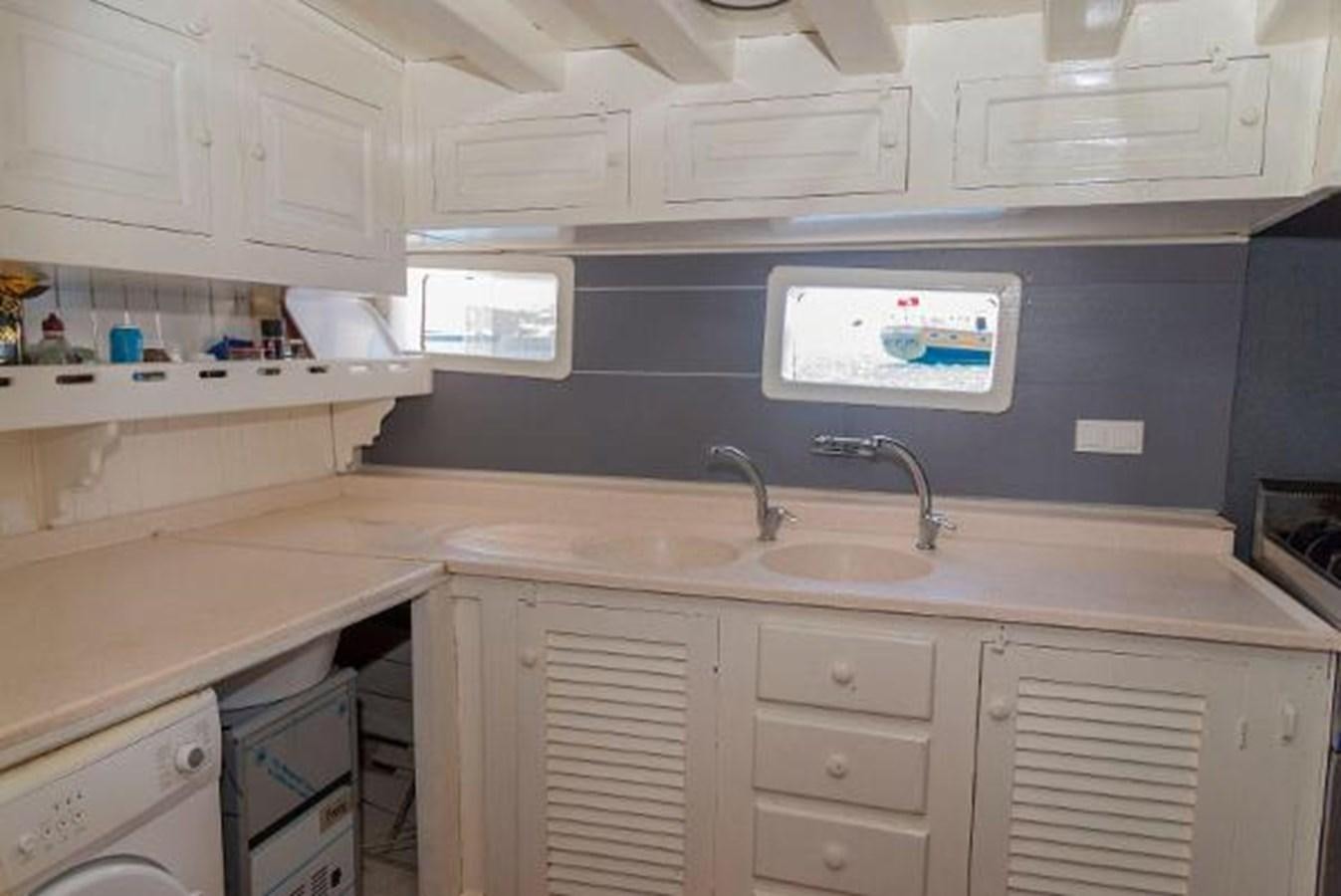 a kitchen with a sink and cabinets aboard 1998 CUSTOM SAILING YACHT Yacht for Sale