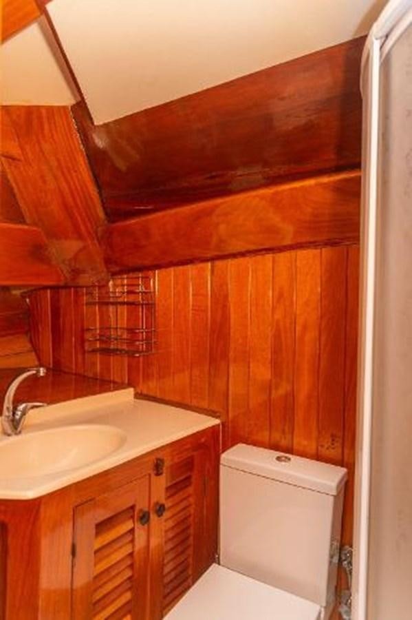 a bathroom with wooden walls aboard 1998 CUSTOM SAILING YACHT Yacht for Sale
