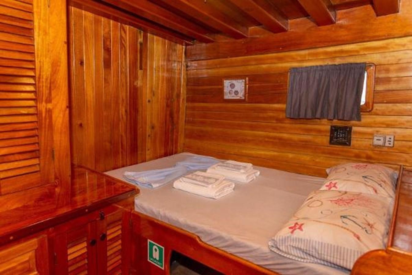 a bed in a cabin aboard 1998 CUSTOM SAILING YACHT Yacht for Sale