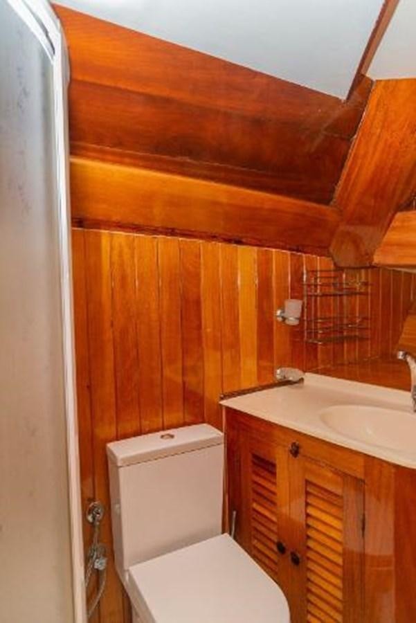 a bathroom with wooden walls aboard 1998 CUSTOM SAILING YACHT Yacht for Sale