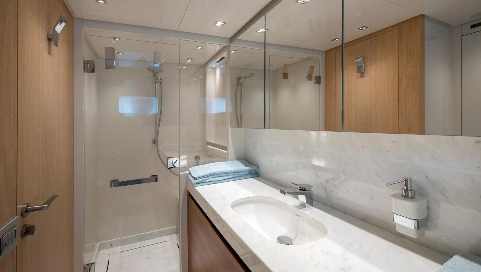 a bathroom with a glass shower aboard 2015 SANLORENZO SL96 #623 Yacht for Sale