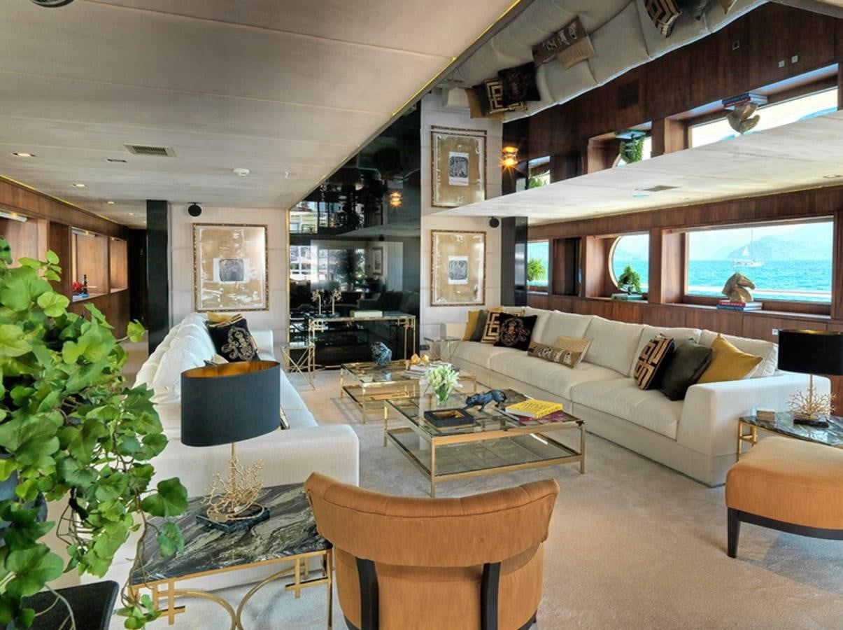 a living room with a couch and a table aboard QUEEN MARE Yacht for Charter