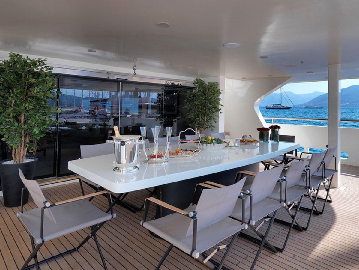 a large white table with chairs around it aboard QUEEN MARE Yacht for Charter