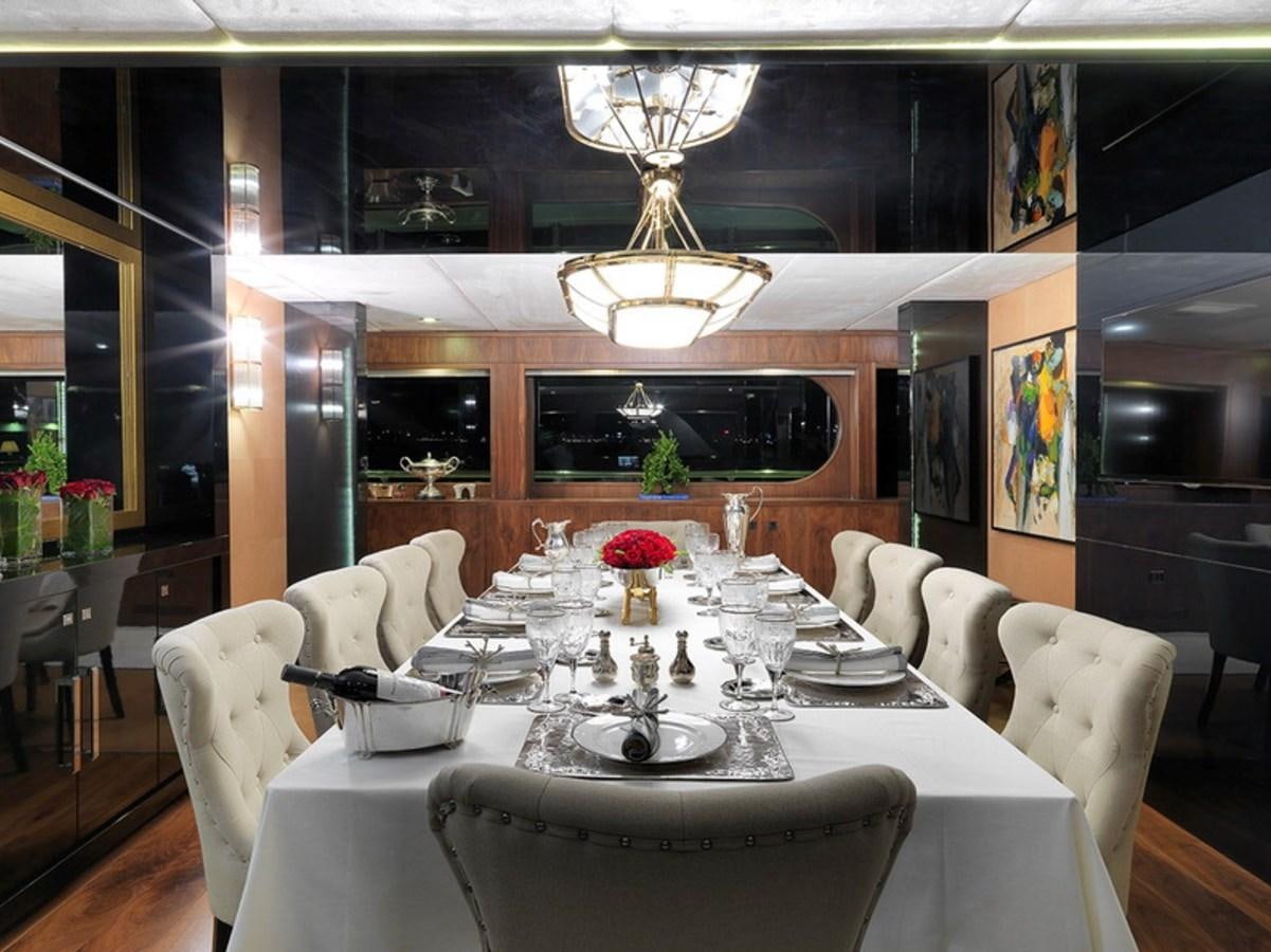 a dining room with a table set aboard QUEEN MARE Yacht for Sale