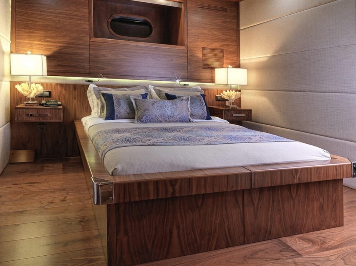 a bed with lamps on either side aboard QUEEN MARE Yacht for Charter