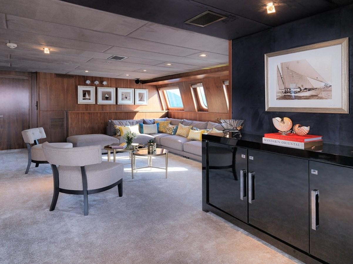 a large living room with a kitchen and dining area aboard QUEEN MARE Yacht for Charter