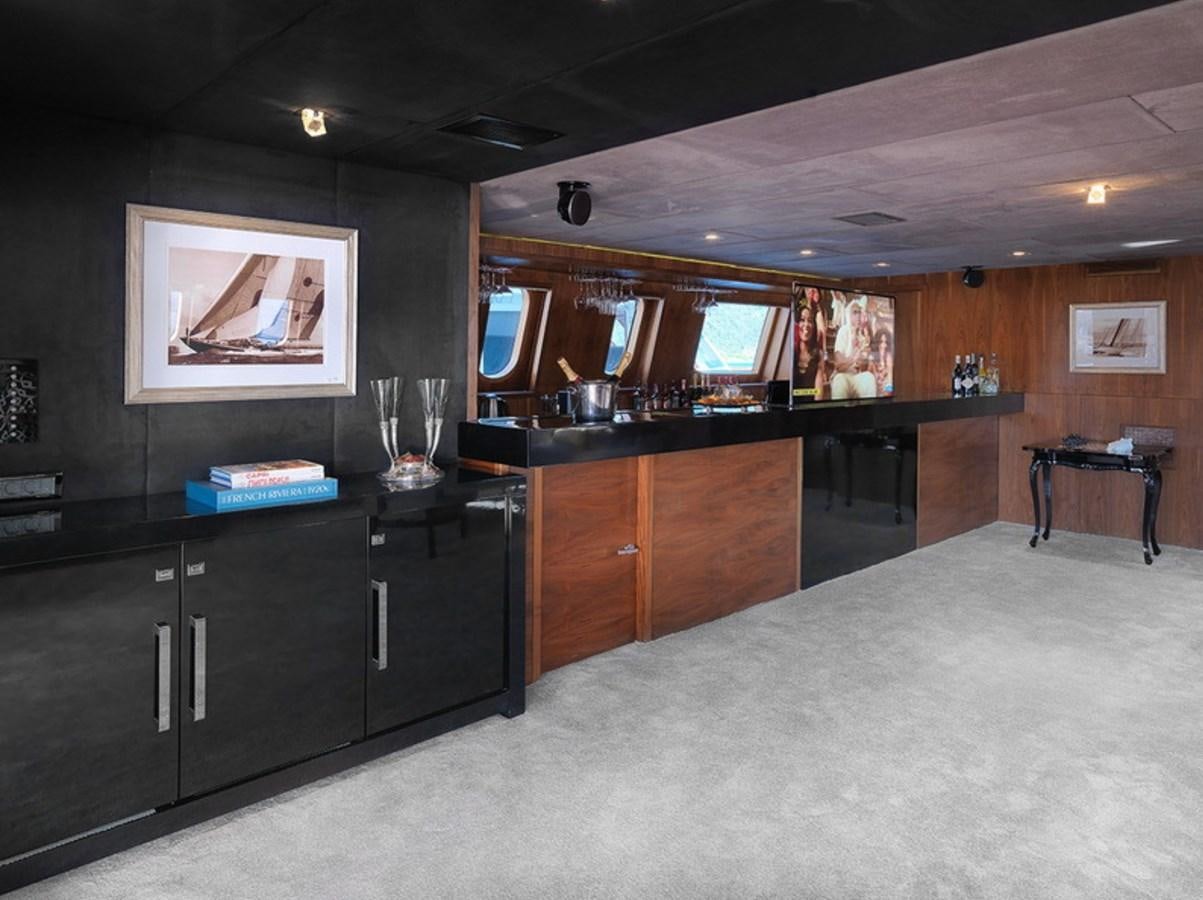 a kitchen with black cabinets aboard QUEEN MARE Yacht for Charter