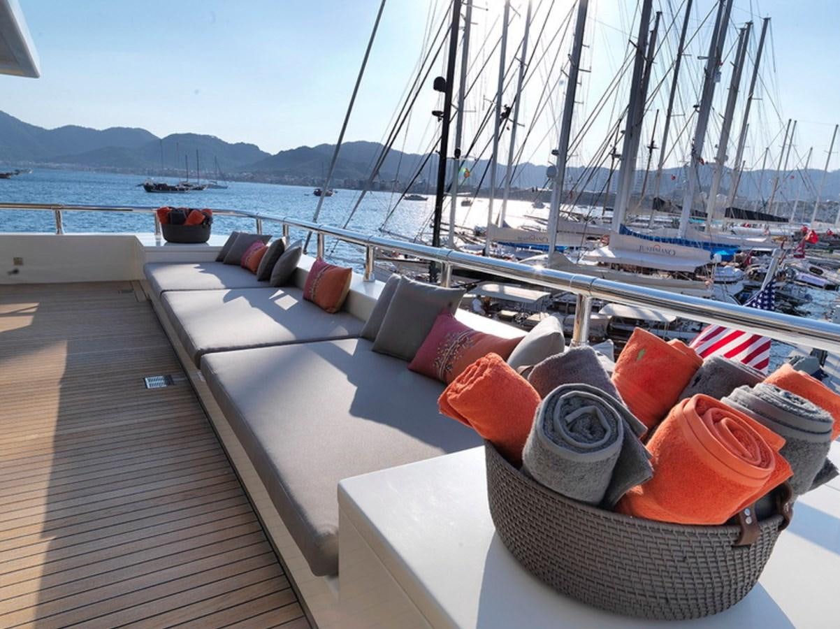 a deck with a view of a city and boats on it aboard QUEEN MARE Yacht for Charter