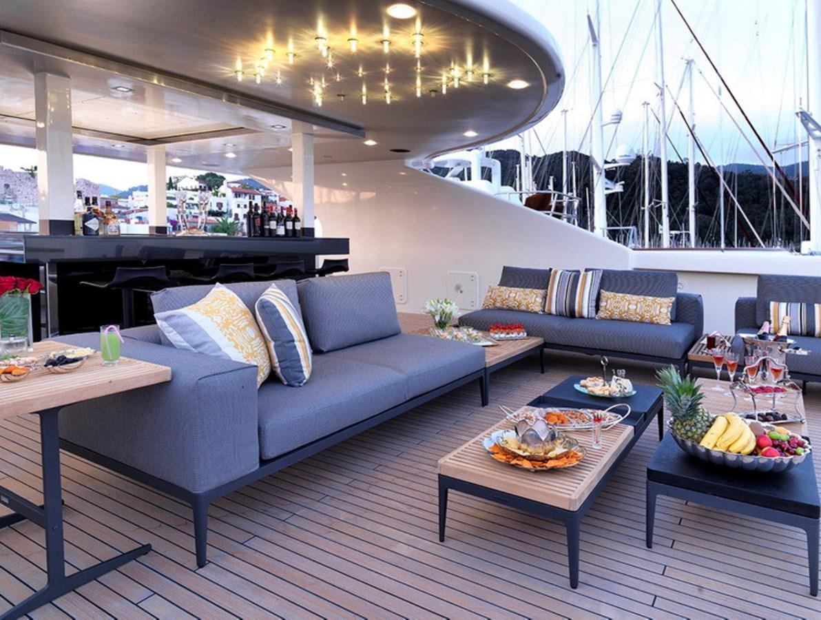 a living room with a couch and a table aboard QUEEN MARE Yacht for Charter